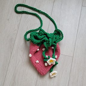 crochet strawberry bag, flat with the top scrunched closed